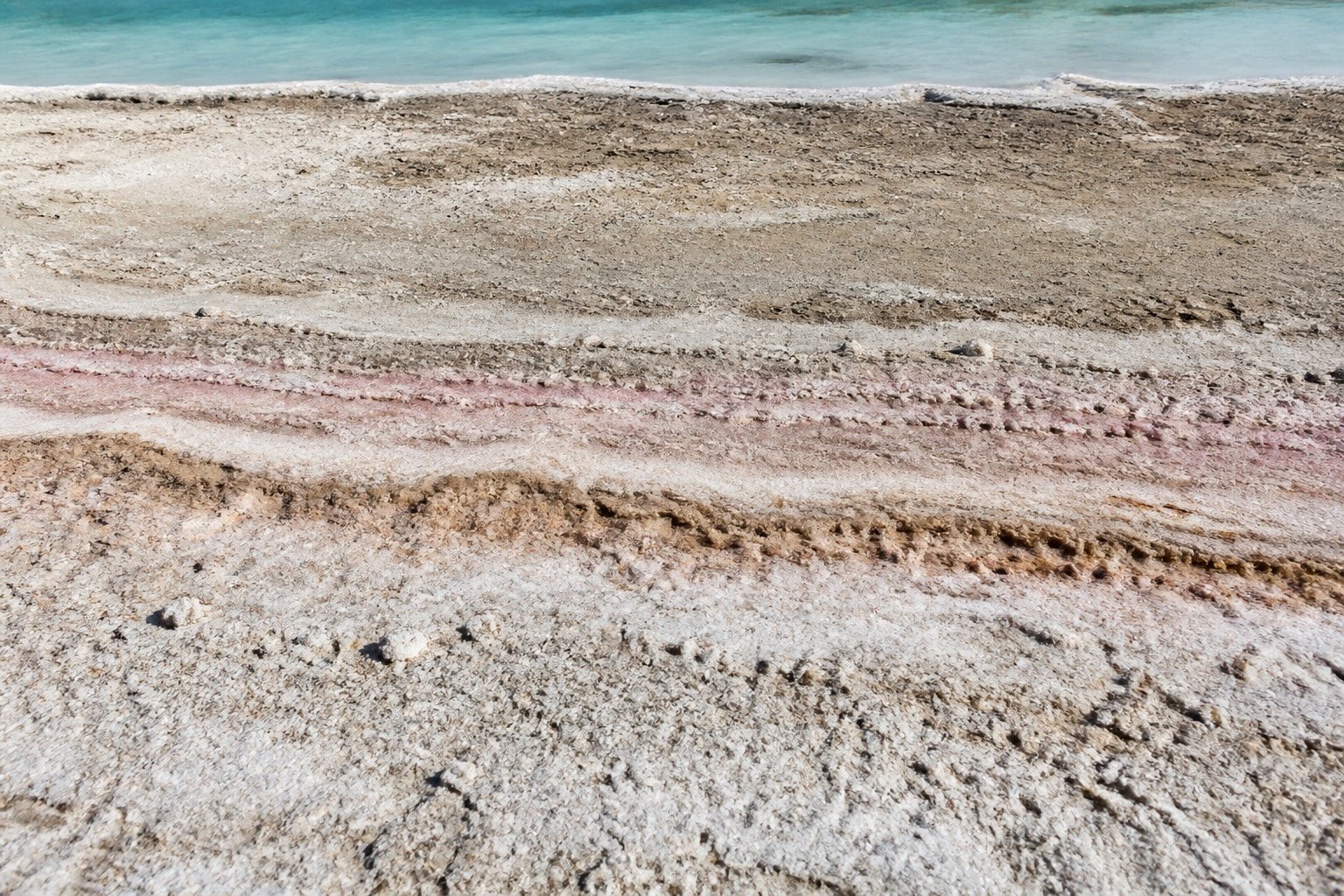 Cloudy diluted brine beside a clear crystalline mineral structure